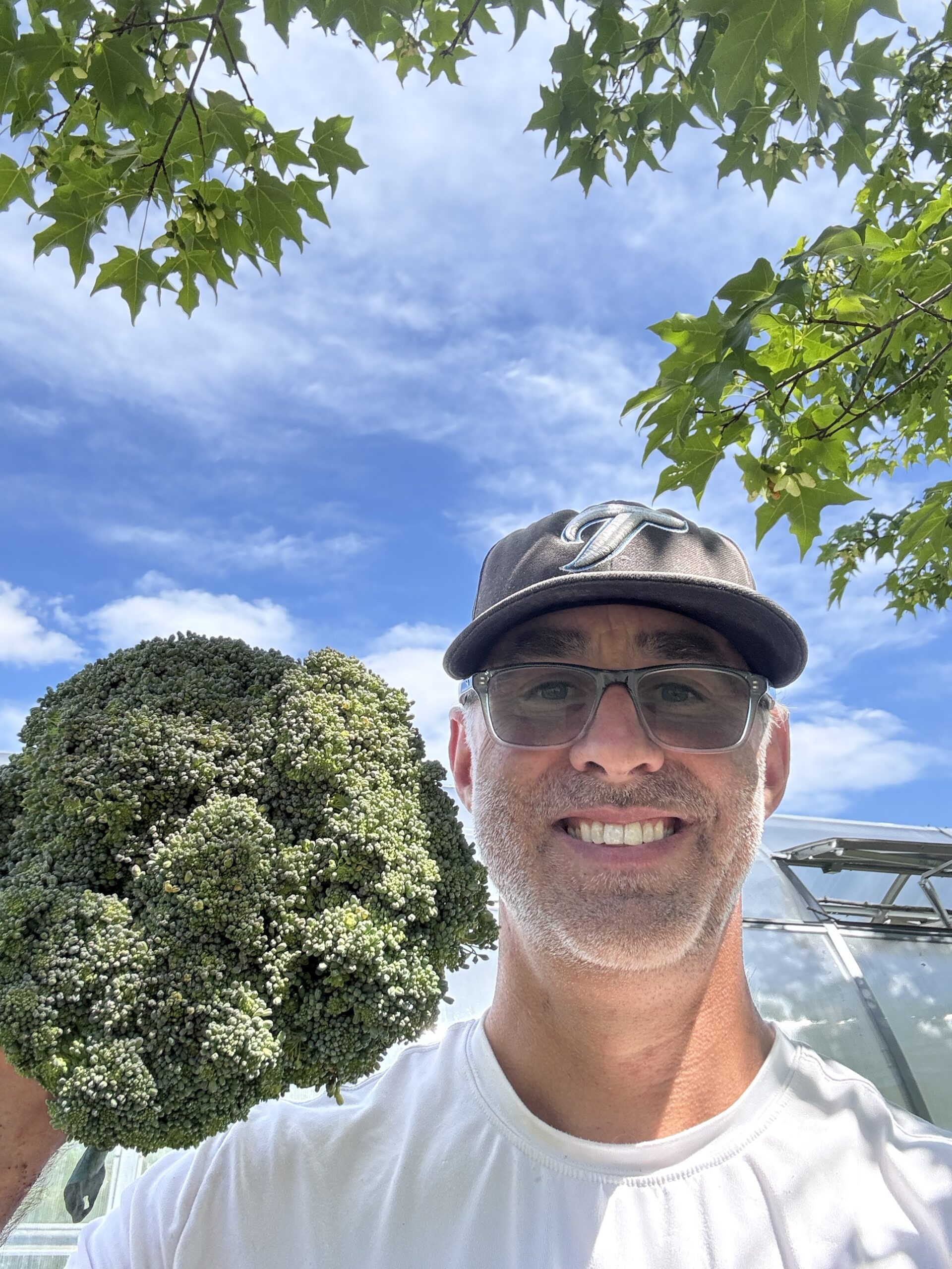 Farmer Jay Smith holding a large head of broccoli